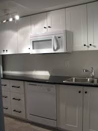 Kitchenette With Adel Off White Cabinets And India Black Galaxy Granite Counters Kitchen Cabinets Brown Kitchen Cabinets Dark Brown Kitchen Cabinets