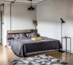 Industrial style bar stools and coffee tables often feature natural textures such as worn leather or knotted wood get inspired: Industrial Style Bedroom With Visible Wiring In 2020 Industrial Style Decor Industrial Style Bedroom Interior