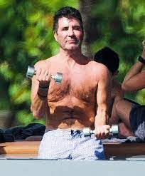 Simon cowell, 61, is seen with a medical breathing apparatus (next to a packet of cigarettes) as he heads home with partner lauren silverman, 43, after a dinner date in london. Shirtless Simon Cowell Lifts Weights In Barbados After Back Injury Hollywood Life