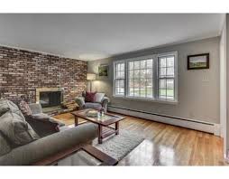 Similar style of frame can be seen on the unique coffee table and the sofa on the left. What Paint Color For A Living Room With Brick Wall