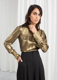 A high neck blouse is designed with ruffled sleeves. Metallic Satin Blouse Fashion Trend Inspiration Metallic Blouses Fashion