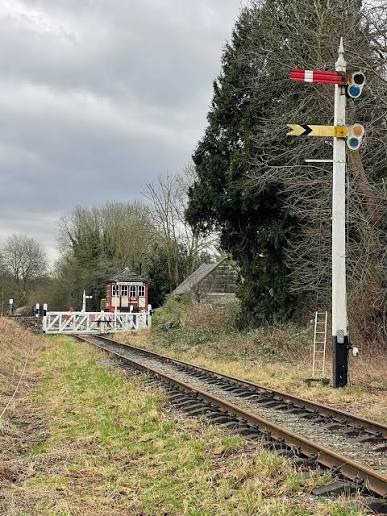 A stereotypical English railway scene! Semaphore track signals, white level crossing gates, Signal Box, on Church Lane. With the looming grey clouds suggesting an umbrella may be needed soon! This is on