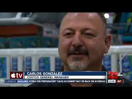 Costco greeter spreading positivity with a smile, song, and cheer