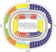 Its metal arch towers in to the sky above the football stand below. England Stadium Wembley Stadium Football Tripper