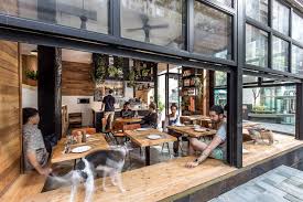 Elephant Grounds Debuts An Airy Nature Inspired Space In The Heart Of Hong Kong S Concrete Jungle Coffee Shop Design Cafe Design Cafe Interior