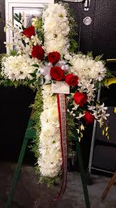 There are many flowers to choose from for a funeral. White Cross With Red Roses Standing Spray Funeral Flowers Funeral Flower Arrangements Flower Arrangements
