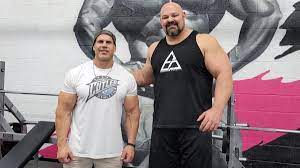 Brian shaw next to bodybuilder