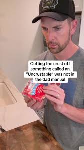 Guy Cutting Frozen Uncrustable