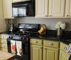 Two Tone Cream Green Cabinets With Dark Countertops And Appliances Thats Even Diy Kitchen Cabinets Painting Painting Kitchen Cabinets Kitchen Inspirations