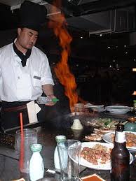 It has become a thing now that when you go to certain japanese restaurants they don't just make you wait for your food, but instead, they actually cook it right in front of you. Teppanyaki Wikipedia