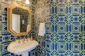 Powder room with green walls, wall lighting, and single vessel sink sitting on an antique vanity. 24 Powder Rooms That Powerfully Pamper You The Chroma Home