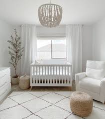To balance the room, a glider sits opposite the crib. Pin By Caroline Stites On Room Makeover Baby Room Neutral Baby Girl Nursery Room Nursery Baby Room