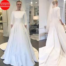 Waight keller, who became the first female artistic director at the historic french fashion house givenchy, was chosen by markle to. Three Quarter Sleeves Wedding Dresses 2020 Meghan Markle Style Boat Neck Buttons Back A Line Bridal Gown White Satin Trouwjurk Wedding Dresses Aliexpress