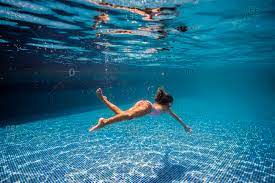 Swimming underwater with clothes on jean shorts underwater tori changing it up today! Young Girl Swimming Underwater In A Pool Stock Photo Offset