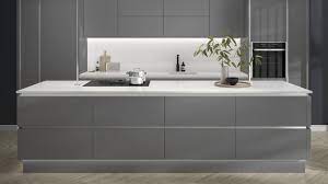 Half height wall units help create the illusion of make a statement with the dark grey tones of this glossy kitchen cabinet door, which is 19mm thick and has streamlined integrated handles. Hockley Mirror Gloss Slate Grey Handleless Kitchen Fitted Kitchens Howdens