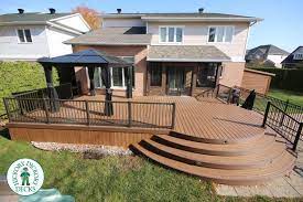 a beautiful armadillo deck with curved steps and the added bonus of a sun room located in ottawa ontario patio design decks backyard patio