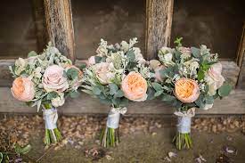 I love the diy details like the paper pinwheel bouquets and the pennant banners that hung around the venue. The Magnificent Combination Of Barn Weddings And Roses Parfum Flower Company