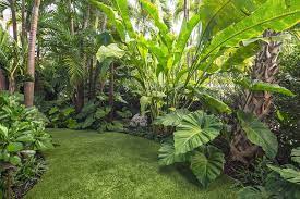The wooden shelves hold the potted flowers to supply pops of colors contrasting the green overall, those tropical backyard landscaping ideas are inspirational for you. 33 Beautiful Tropical Garden Design Ideas You Must Have Tropical Garden Design Tropical Landscape Design Tropical Backyard Landscaping