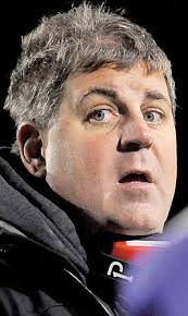 Coach slips off dancing shoes to put