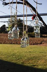 23 Magical Outdoor Hanging Decoration Ideas To Bring Your Patio To Life Flower Bottle Bottles Decoration Glass Bottles