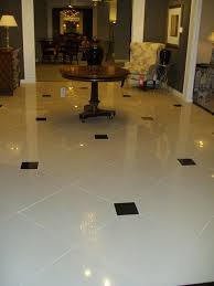 24x24 Lv Linen Porcelain With Polished Black Marble Inserts Used In Toronto S Renowned Art Shoppe Tile Floor Flooring White Tile Floor