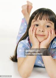 Portrait Of Girl Lying On Hardwood Floor At Home Romania High-Res Stock  Photo
