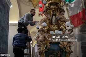 The float containing the relics of Saint Agatha is surrounded by... News  Photo