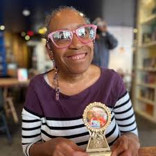 Eileen LOVES trophies (and medals), so we thought there was no better way  to celebrate her incredible work as L'Arche GWDC's Friendship Builder for  the past 12 years than her very own