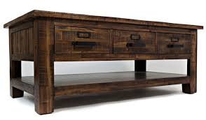 This coffee table with a natural acacia wood construction offers both great durability and classic style to your lounge space. Acacia Wood Distressed Coffee Table Christian S Table