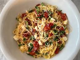 The angel hair pasta is tossed with a fresh tomato and basil sauce and topped with parmesan cheese. Angel Hair With Roasted Tomatoes Mozzarella And Basil The Buzz Magazines