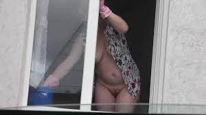 Sexy MILF in dressing gown without panties and bra washes windows of  apartment. Driver looks out of car. Exhibitionist - XNXX.COM