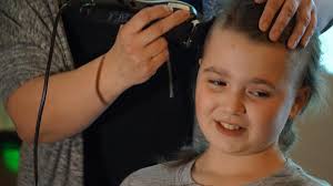 Kind-hearted Elle loses locks for Macmillan