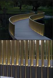 Give your home's exterior a lift with this rubbed bronze outdoor wall light. Minimalist Lighted Slat Bridge Railing Deck Railing Mountain Laurel Handrails Nationwide Handrail Design Outdoor Lighting Design Railings Outdoor