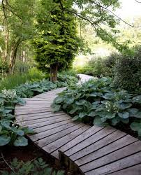 Click this article to learn about creating a dry creek bed in the landscape. 25 Catchy And Cozy Wooden Garden Paths Shelterness