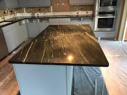 Black and white marble slab countertops and splashback provide an amazing contrast to the white kitchen cabinets in this small apartment kitchen by ashley tracey & laura mclellan toronto design. Add Luxury To Your Kitchen With Black Marble Countertops Moreno Granite