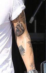 Small black late late tattoo on harry's left sleeve, just below his heart tattoo 60. 1d Updates On Twitter Harry Styles Tattoos One Direction Harry Harry Styles