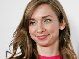 Lauren Lapkus brightens a blue sofa with a joyful accessory