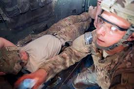 U.S. Navy Hospital Corpsman Aaron Maczuga, right, a