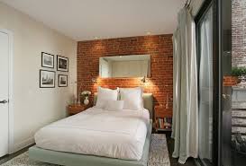 Red brick lined with white sets off a chrome lighting centrepiece and stark tiled floors. 75 Impressive Bedrooms With Brick Walls Digsdigs