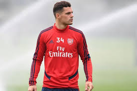 The red jersey features a switzerland national team emblem, puma logo and swiss flag emblem along with a number 23 on the front and additional puma logos on the shoulders. Granit Xhaka Sends Message To Liverpool S Xherdan Shaqiri Over Switzerland Captaincy Feud Football London