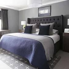 The walls are gray bricks and surround a neutral colored headboard. What Color Bedding For Dark Grey Headboard