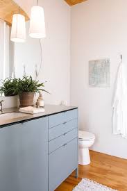 By painting the shelves the same color as the wall, the eye is not immediately drawn to them and they don't feel overwhelming. 60 Best Small Bathroom Decorating Ideas Tiny Bathroom Layout Decor Tips Apartment Therapy