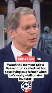 BREAKING: Watch the moment Scott Bessent gets called out for cosplaying as  a farmer when he’s really a billionaire investor. , Follow  @reallyamericanmedia for more