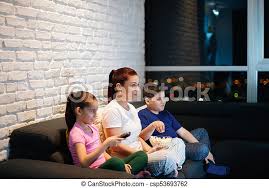 In some ways modern family is so reflective of where many american families find themselves these days, much of the humor stems amazing laugh moments with mzy husband with lots of popcorn. Single Mother And Children Watching Tv At Night Movie Night At Home With Divorced Mother Daughter And Son Modern Family Canstock