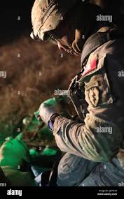 Staff Sgt. Abel Carlos, Combat Medic Specialist, 25th Infantry Division,  carry a skid litter during an physical training exercise for the Army's  Best Medic Competition. Twenty-two two-Soldier teams from all around the