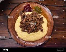 Sauteed Reindeer Meat With Mashed Potatoes Lingonberry Sauce And Pickles Traditional Lappish Meal Served By Open Atrium Fire Pit At Finnish Restaurant Stock Photo Alamy