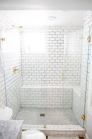 White subway tiles with dark grout do we like it? Glass Enclosed Walk In Shower Featuring White Subway Tiles With Black Grout And A Polished Br Black Grout White Subway Tiles White Subway Tile With Black Grout