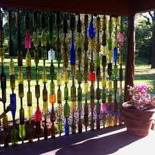 Using Glass Bottles In The Garden Wine Bottle Fence Bottle Wall Bottle Crafts