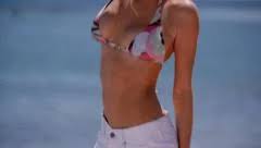 Mildly erotic, with the innocence of yesterday. Brunette Girl On Beach Strips Down To Bi Stock Video Pond5