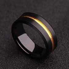 A few decades ago, a man casually sporting rings or a chunky bracelet was tungsten rings are our favorites when it comes to men's jewelry and we found 10 we think are perfect for any man out there! Men S Black Tungsten Ring With Gold Groove Opulent